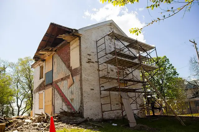 Scaffolding around an old brick house for masonry repairs